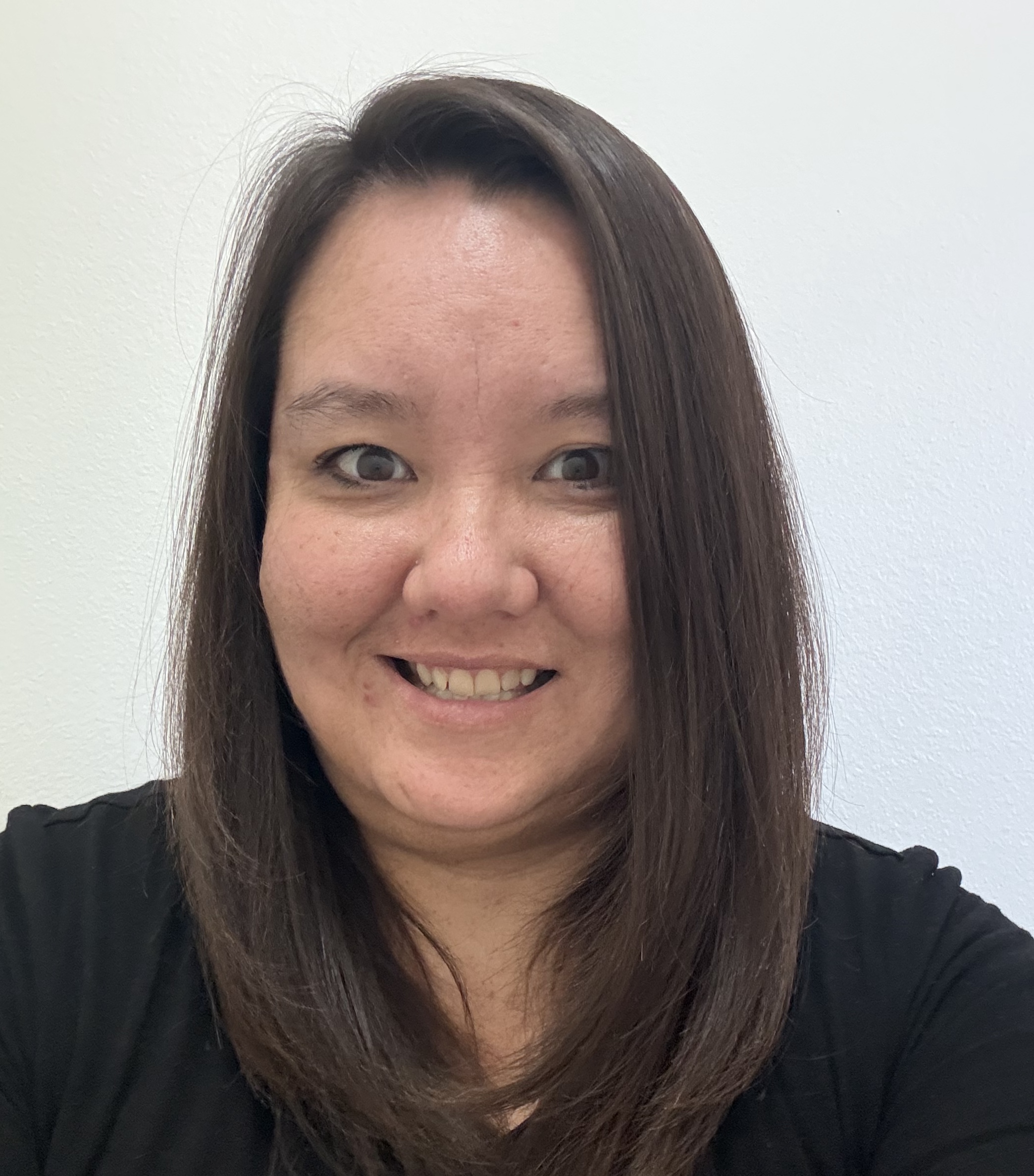 Headshot of Kimiko wearing a black shirt.