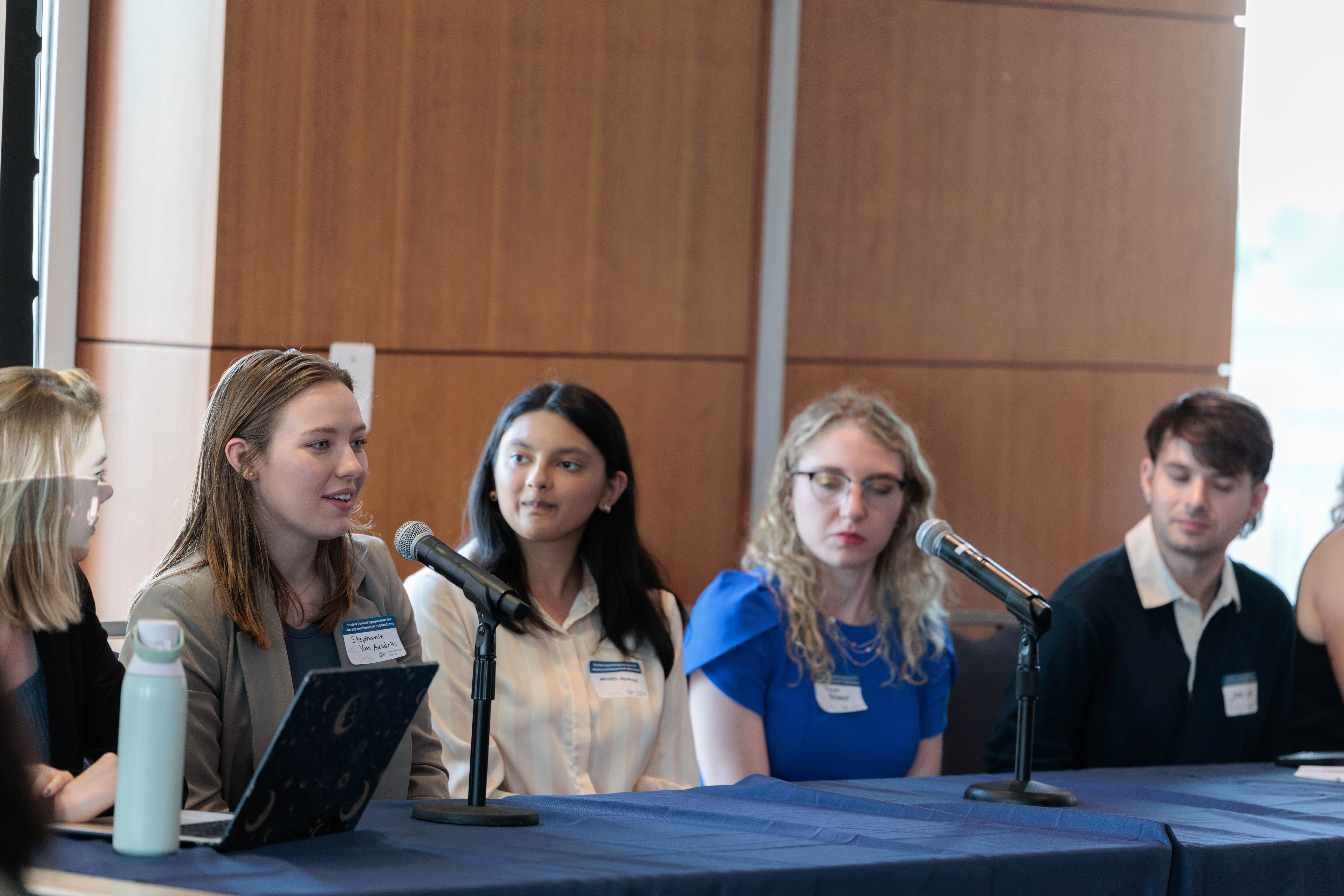 Students seated at a table for the 2025 Student Symposium.